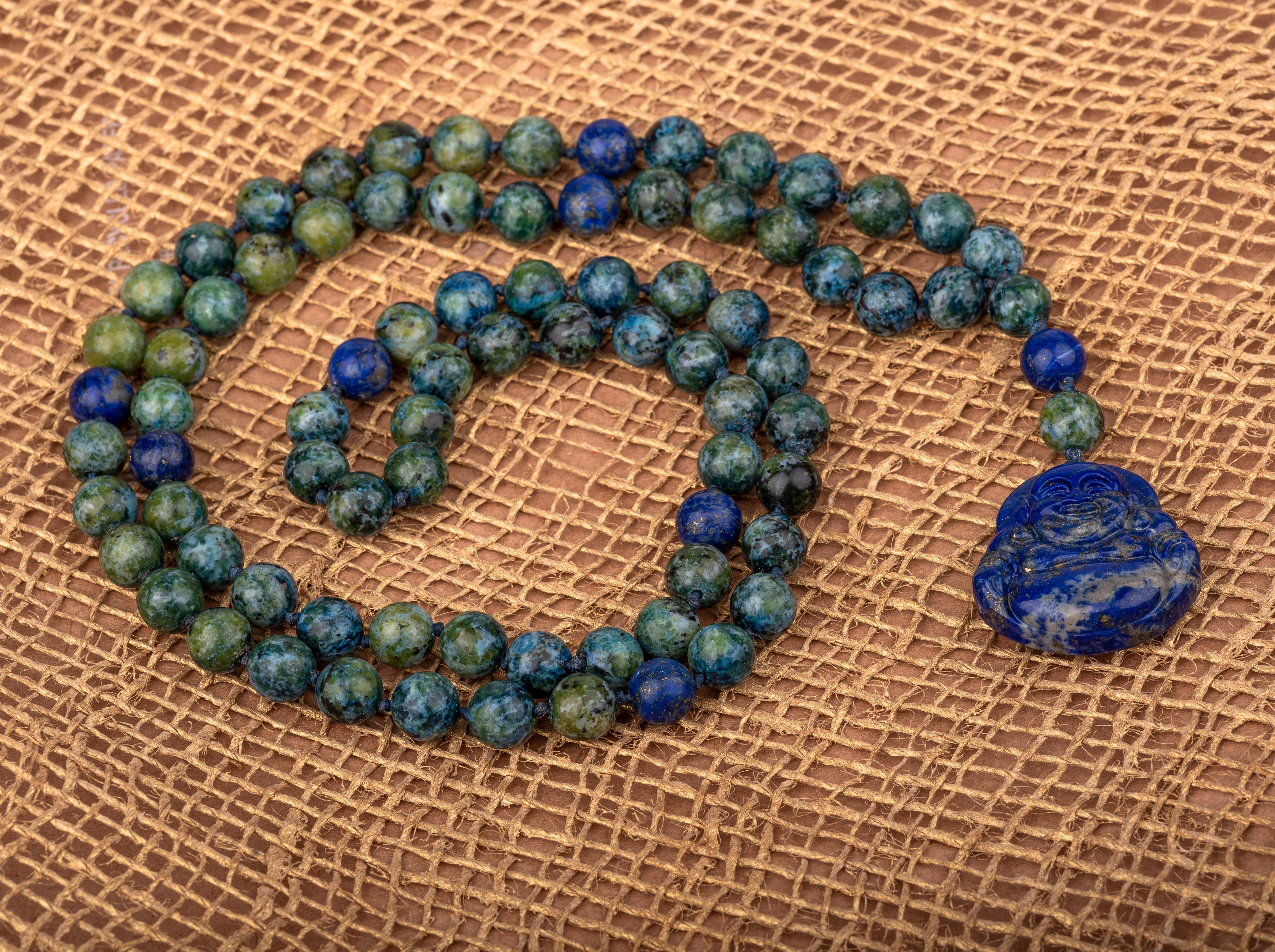 Buddah Lapis lazuli pendant with azurite and lapis lazuli beads .