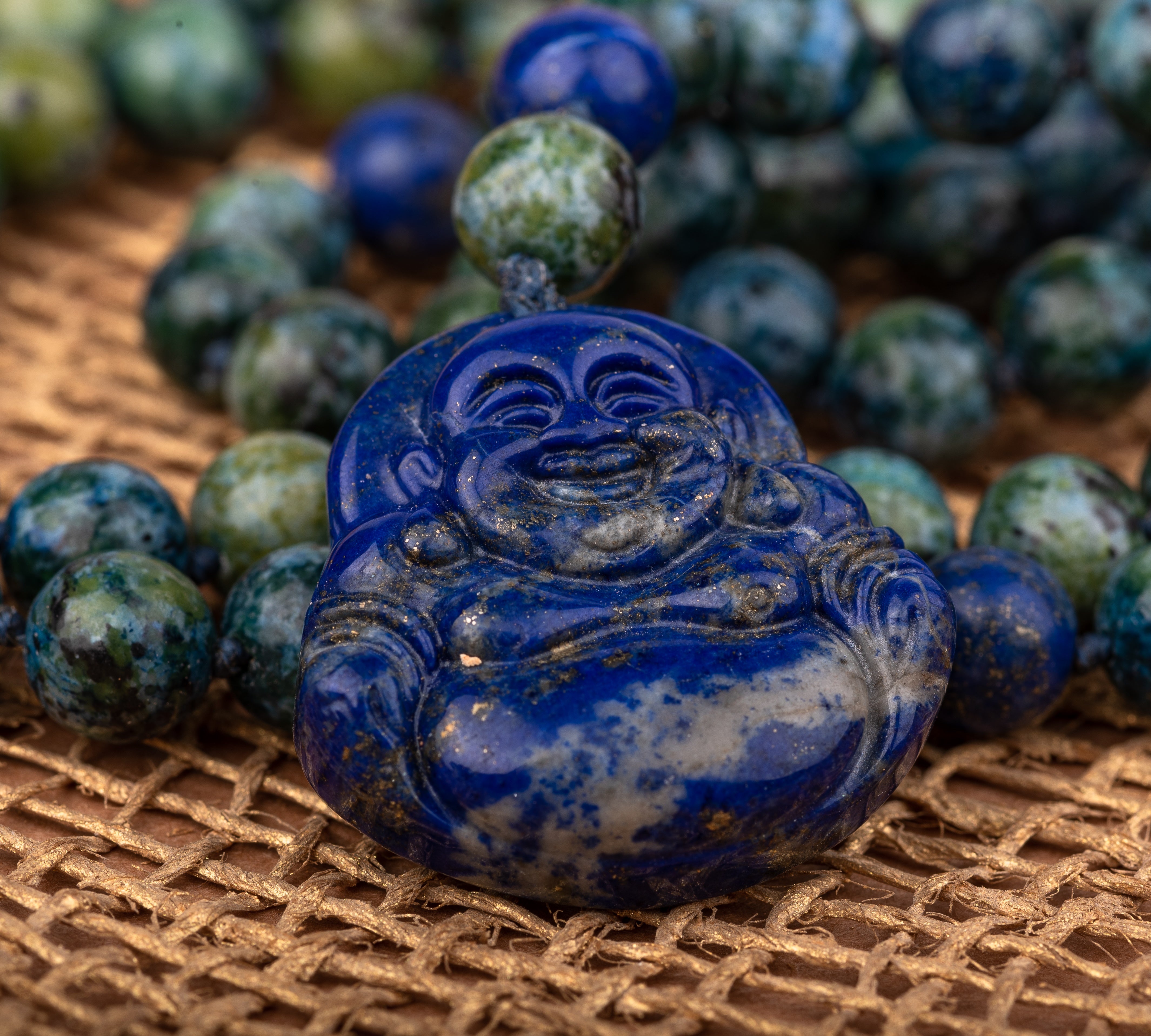 Buddah Lapis lazuli pendant with azurite and lapis lazuli beads .