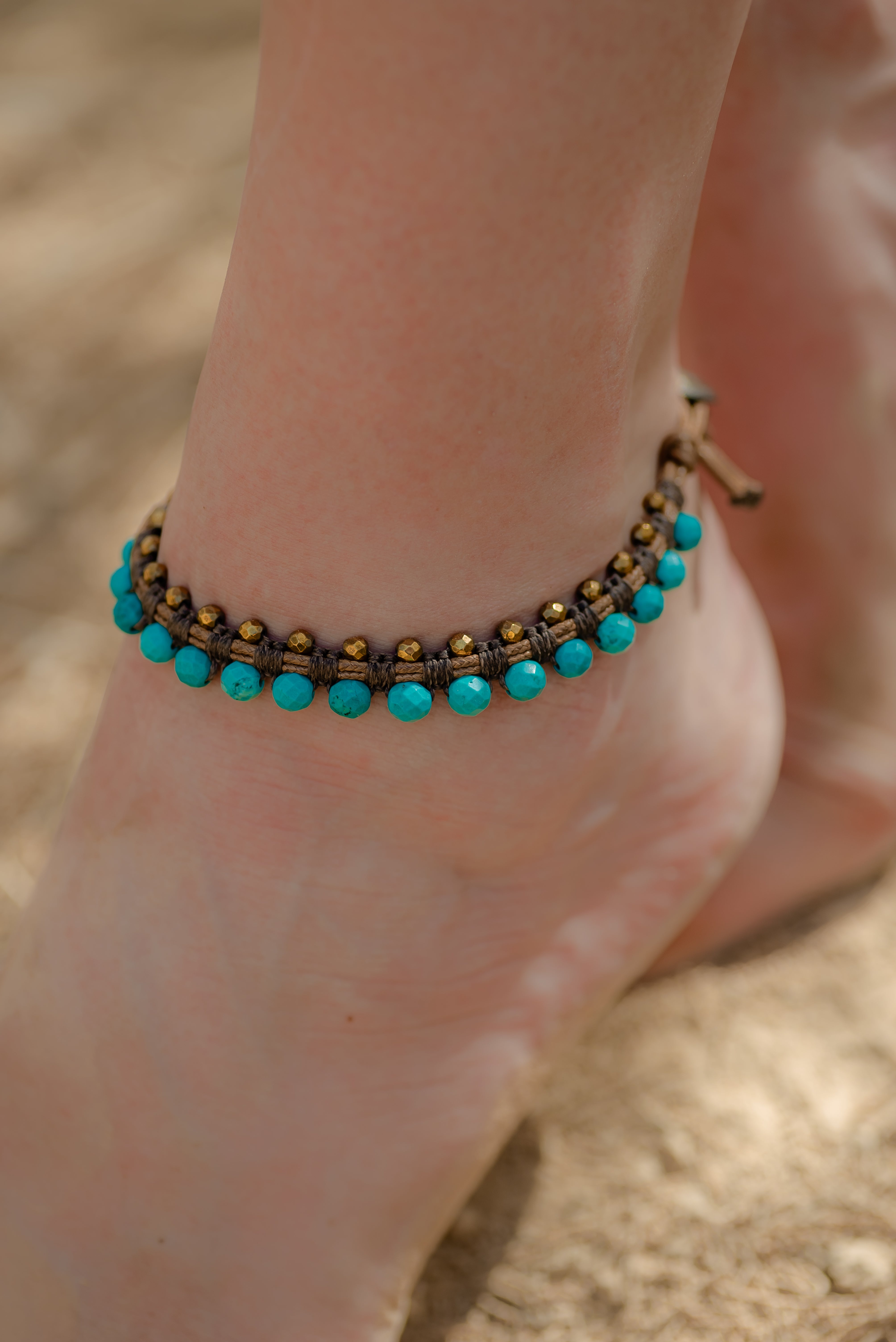 turquoise howalite with gold hematite wrapped with leather macramé anklet.